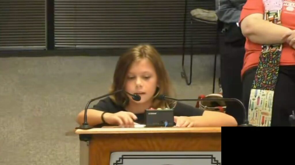 Student speaking at Wake County school board podium during public comment